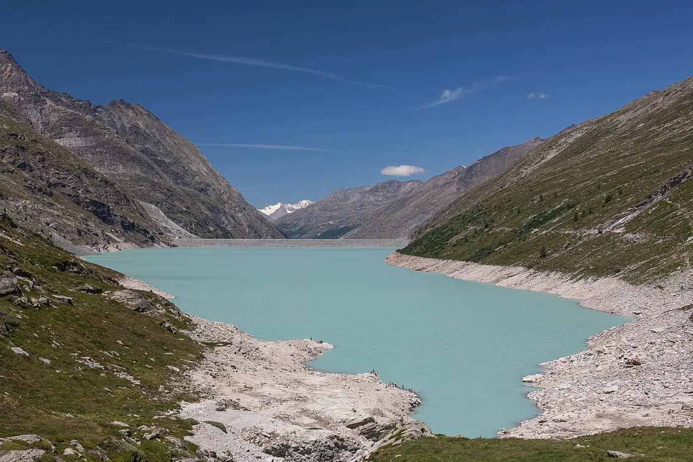 Mattmark reservoir shoreline with alpine peaks beyond